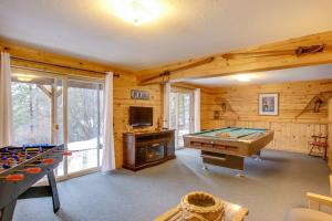 a game room with a pool table and a tv at Cave Bay Vacation Rental with Game Room! in Worley
