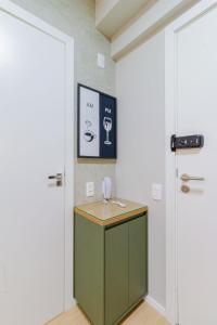 Cette chambre comprend une armoire verte et une porte. dans l'établissement Apartamentos completos ao lado do metrô, Vila Madalena, à São Paulo