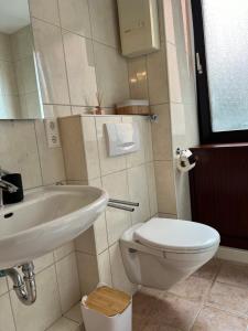 a bathroom with a white toilet and a sink at Medina in Düsseldorf