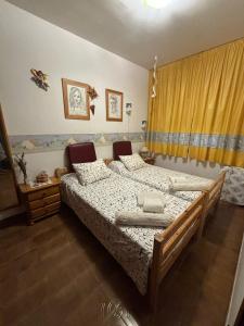 a bedroom with a bed and a yellow curtain at Calella Playa in Calella