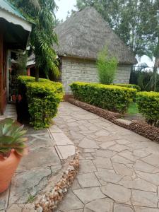 a stone walkway in front of a house at Pine Breeze Getaway LUKENYA in Athi River