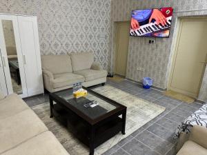 a living room with a couch and a tv at العين الهيلي مصباح ب 11 in Al Ain +4 photos