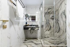 a bathroom with a shower and a sink at РИМ Grand Hotel in Almaty +99 photos