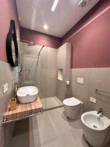 a bathroom with a toilet and a sink and a tub at Blu Parthenope a Spaccanapoli in Naples +25 photos
