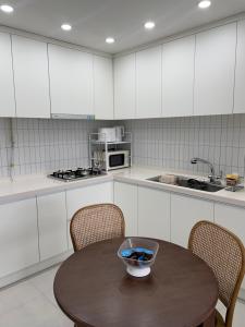 a kitchen with a table with a bowl on it at Asla stay in Incheon