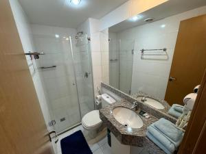 a bathroom with a sink and a shower and a toilet at Suite Particular no Hotel S4 Águas Claras in Brasília