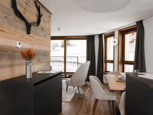 a kitchen and dining room with a table and chairs at Duplex plein sud à Courchevel Village - 4 pers - Pieds des pistes, balcons, parking, casier à skis - FR-1-631-73 in Courchevel
