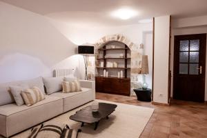 a living room with a couch and a table at Mount Minis - Casa Bruno in Syvota