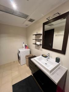 a bathroom with a sink and a washing machine at Апартаменты в Вари in Vari +16 photos