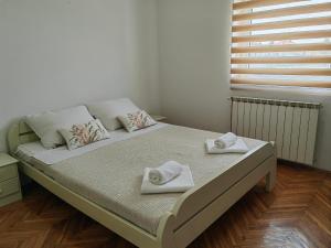 Postel nebo postele na pokoji v ubytování Orient Apartman