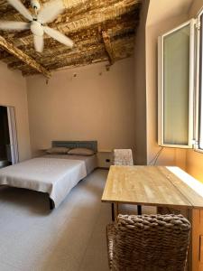 a bedroom with a bed and a table and chairs at Trulli & Case Fichi 3 in Bari