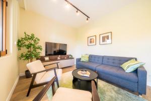 a living room with a blue couch and a table at Bradasevic Apart Resort Tivat lux in Tivat