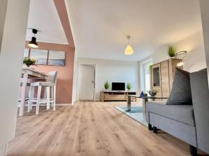 a living room with a couch and a table at FeWo Metje - Horumersiel in Wangerland