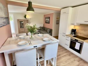 a kitchen and living room with a table and chairs at FeWo Metje - Horumersiel in Wangerland