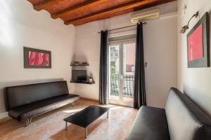 a living room with a couch and a window at Stay U-nique Apartments Nació in Barcelona
