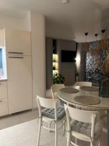 a kitchen and dining room with a table and chairs at Naluri Apartman II in Balatonboglár