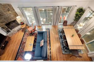 an aerial view of a living room with a blue couch at Cabin w Hot Tub, WiFi, Deck, Grill & Dog-Friendly! in Berkeley Springs