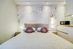 a bedroom with a large bed with two pillows on it at Stylish apartments - near Zadar bridge in Zadar