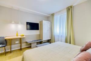 a hotel room with a bed and a desk and a tv at Stylish apartments - near Zadar bridge in Zadar