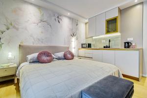 a bedroom with a large bed with two pillows at Stylish apartments - near Zadar bridge in Zadar