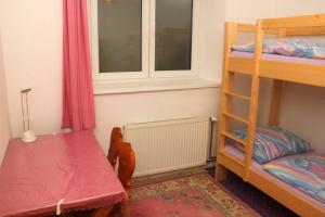 a room with a table and a bunk bed at U Melicherů in Suchdol nad Lužnicí