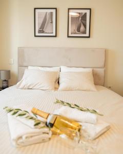 a bed with two towels and two bottles on it at Bradasevic Apart Resort Tivat lux in Tivat