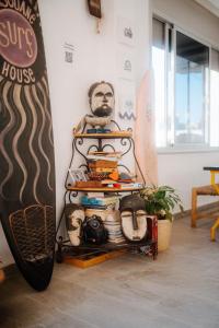 a rack with a surfboard next to a wall at Imsouane surf house in Imsouane