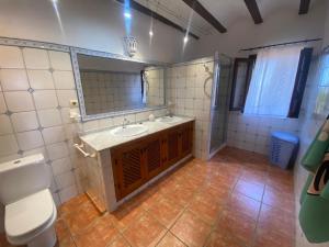 a bathroom with a sink and a toilet and a mirror at Los Almendros in Torrenostra +28 photos