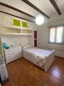 a bedroom with a bed and a sink and cabinets at Los Almendros in Torrenostra