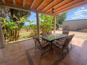a glass table and chairs on a patio at Los Almendros in Torrenostra