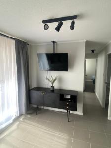 a living room with a flat screen tv on the wall at Departamente full equipado in Vallenar