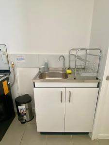 a kitchen sink with a basket on top of it at Departamente full equipado in Vallenar +3 photos