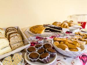 a table filled with different types of bread and pastries at Sangaggio House B&B in Florence