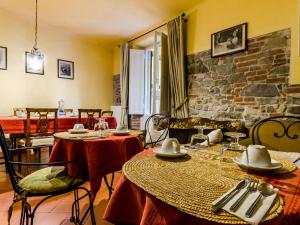 a dining room with two tables and a stone wall at Sangaggio House B&B in Florence