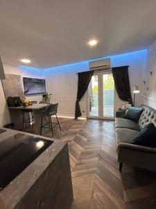 a living room with a couch and a table at Delfa Luxe Suite-Sustainable Luxury & EV Station in Supetar