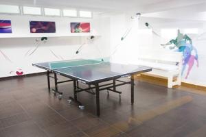 a ping pong table in a room with a couch at Marbella AquaVista 11-18 in Juan Pedro