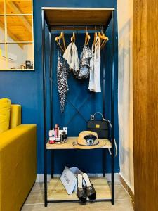 a blue room with a table and some clothes at Katoi suite in Éxo Khóra