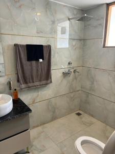 a bathroom with a shower and a sink and a toilet at Bhullars villa in Sohāna +22 photos