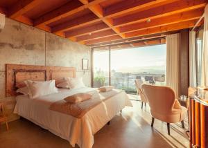 a bedroom with a bed and a large window at Casa das Ameias in Vouzela +96 photos