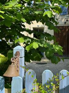 a blue fence with a bell on top of it at Typical French House near Disneyland & Paris in Coupvray