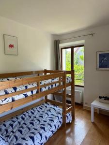 a bedroom with bunk beds in a room with a window at Typical French House near Disneyland & Paris in Coupvray
