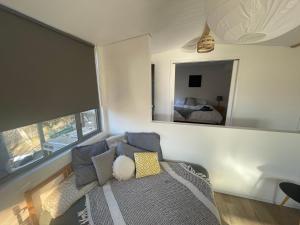 a living room with a couch and a mirror at Northglow by REthynk in Jindabyne