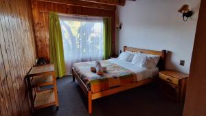 Postel nebo postele na pokoji v ubytování Alpes Hotel