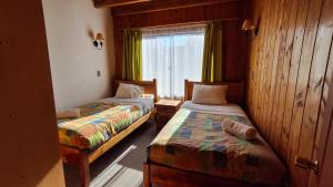 Postel nebo postele na pokoji v ubytování Alpes Hotel
