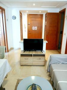 a living room with a flat screen tv on a table at Studio très haut standing avec vue dégagée in Tunis