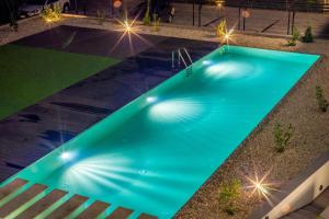 an overhead view of a swimming pool at night at LAKE MOMENTS - Ruby Garden Apartment in Balatonszemes