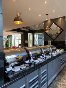 a buffet line with white dishes on in a restaurant at International Airport Flat - Guarulhos quarto 1267 in Guarulhos