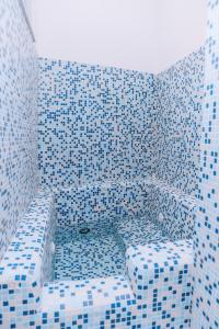 a blue and white tiled bathroom with a tub at Omare Apartments in Sant'Angelo D'Ischia +180 photos
