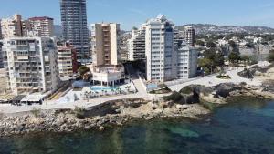 an aerial view of a city with buildings and water at Horizonte beachfront apartment in Ifach