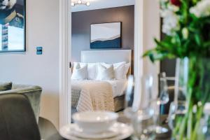 a bedroom with a bed and a mirror at 2 Bedroom Apartment Leeds City Centre - Free Parking in Leeds +60 photos